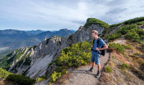 Hiker on hiking trail, Bayrischer Schinder, Tegernsee mountains in the Mangfall mountains, Germany,