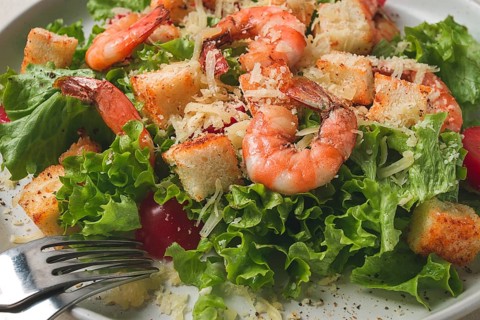 Caesar salad, with shrimp, on a white background, homemade, no people