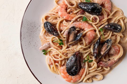 Spaghetti, pasta, with seafood, shrimp with mussels, in creamy garlic sauce, homemade, no people