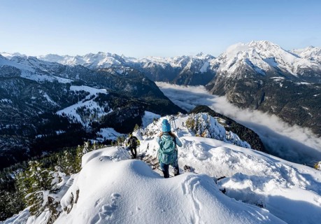 Mountaineers on the snowy summit of the Jenner in autumn, view of the sea of clouds and the