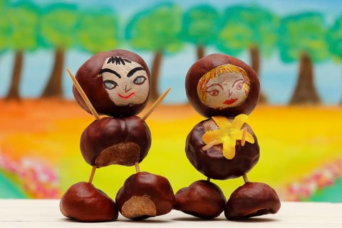 Two cute chestnut figures in front of a painted background, North Rhine-Westphalia, Germany, Europe