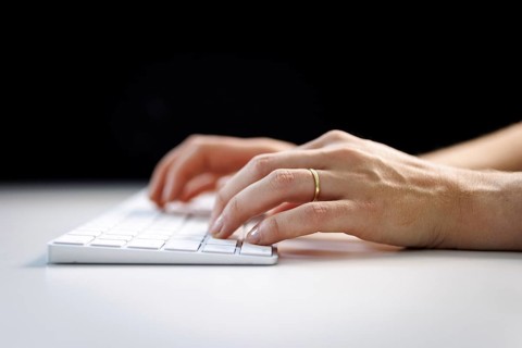Hands typing on a keyboard in Berlin, 09/08/2024