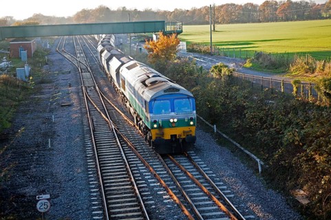 Diesel locomotive freight train on the West Coast mainline at Woodborough, Wiltshire, England, UK