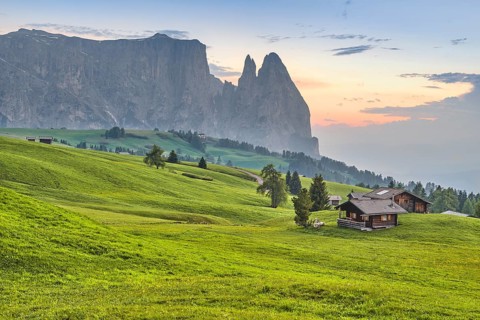 Alpine huts in front of Schlern at sunset, Seiser Alm, Dolomites, South Tyrol, Italy, Europe