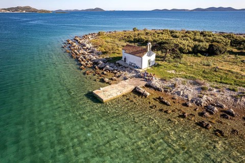 The island of Sveta Justina with the church of St Justina seen from the air, Pakostane, Croatia,