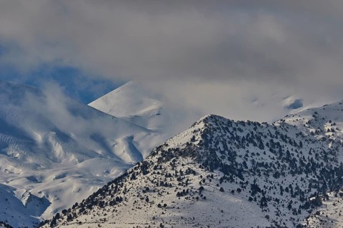 Snow-covered mountain range under a cloudy sky, Lefka Ori, White Mountains, mountain massif, west,