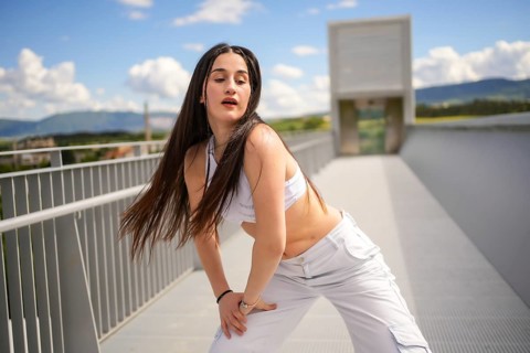 Three quarter length portrait of a caucasian beauty young woman performing urban dance in an