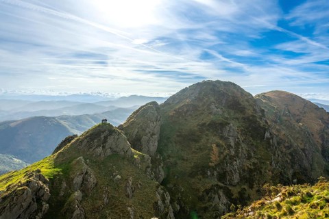 Hikers enjoy the stunning panoramic view from the summit of aiako harria, also known as penas de