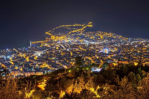 The lights of the city of Alanya on the Turkish Riviera glow in the evening, Alanya, Antalya,