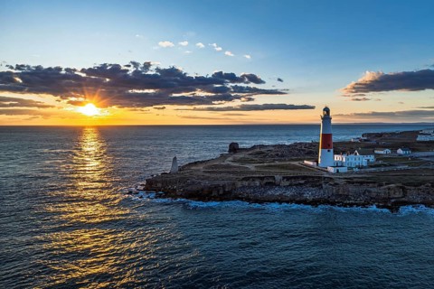 Sunset over Portland Bill Lighthouse from a drone, Portland Bill, Isle of Portland, Dorset,