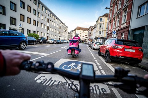 Cycling in the city, city centre road, cycle lane, two-wheeled traffic has priority, 30 km/h zone,