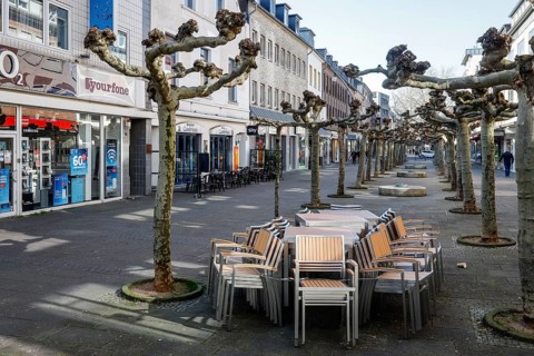 Deserted shopping street with closed shops due to corona pandemic contact ban, main street in the