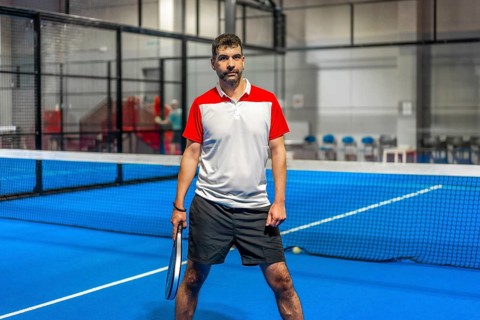 Portrait of a sportive mature adult caucasian man in a paddle tennis court