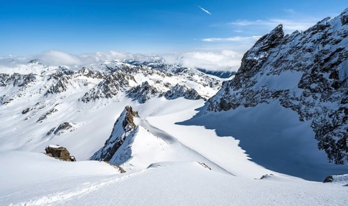 Mountain ridge of Piz Kesch, ascent on Piz Kesch or Piz d'Es-cha in winter, spectacular mountain