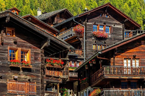 Old wooden houses decorated with flowers in the historic village centre, Grimentz, Val d'Anniviers,