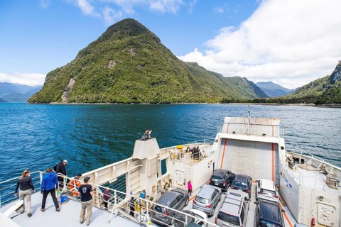 Passengers view the mountains and fjord landscape on the car ferry between Hornopirén and Caleta