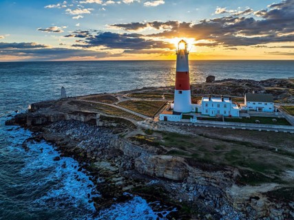 Sunset over Portland Bill Lighthouse from a drone, Portland Bill, Isle of Portland, Dorset,