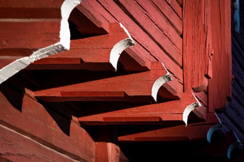 Detail of falun red painted wooden construction, detail of traditional Norwegian wooden granary or