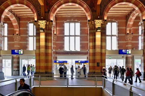 Interior view of Centraal Station, Central Station with flag, Amsterdam, Netherlands