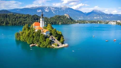 Aerial view of lake bled island with pilgrimage church of the assumption of maria on a sunny summer