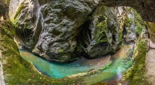 Scenic landscape showing tolmin gorges carving through rock formations with crystal clear turquoise