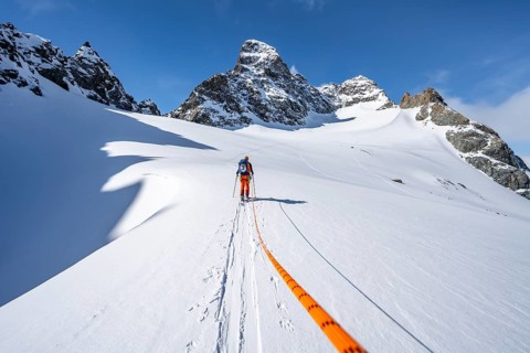 Ski tourer with rope, rope team on the Vadret da Porchabella glacier on the ascent to the summit of