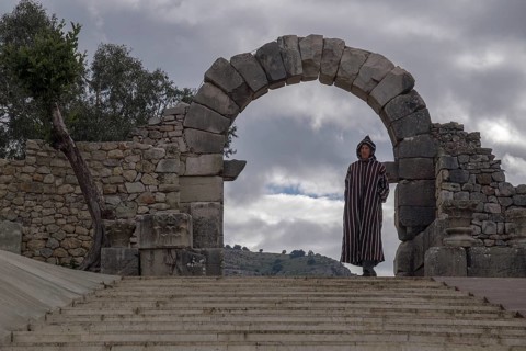 Man with djellab in the ruins of Volubilis, UNESCO World Heritage Site, Mulay Idris, Meknes,