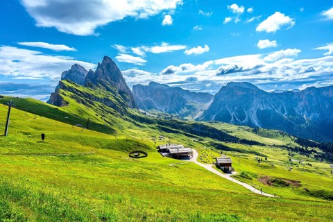 Stunning view of seceda peaks and green meadows in the italian dolomites on a sunny summer day