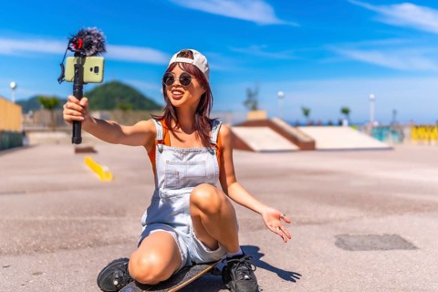 Chinese young female streamer vlogging online in a skate park