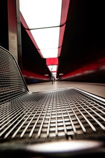 Modern underground station with metal bench and red lighting effects, Hafencity University,