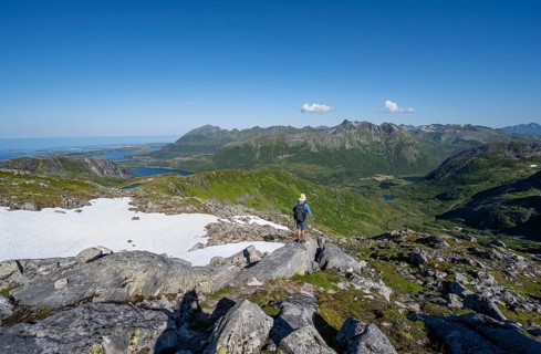 View of mountains and fjord landscape, mountain panorama, mountaineer at the summit of Rundfjellet,