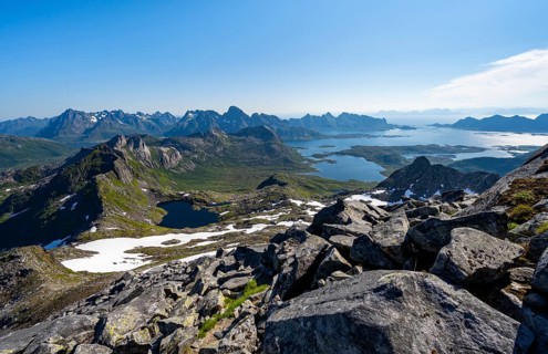 View of mountains and fjord landscape, mountain panorama, mountaineer at the summit of Rundfjellet,