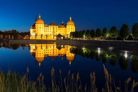 Castle with reflection in the castle pond in the evening, Moritzburg, Saxony, Germany, Europe