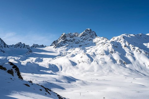Mountain peak Piz Kesch with snow, view at the Kesch hut in winter, Grisons Haute Route, Albula