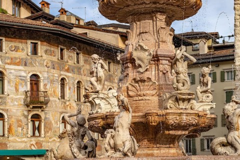 Fountain of Neptune and the painted façade of the Case Cazuffi Rella houses on Piazza del Duomo in
