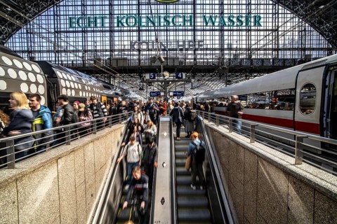 Cologne Central Station, escalators to and from the platform, passengers waiting for the train,