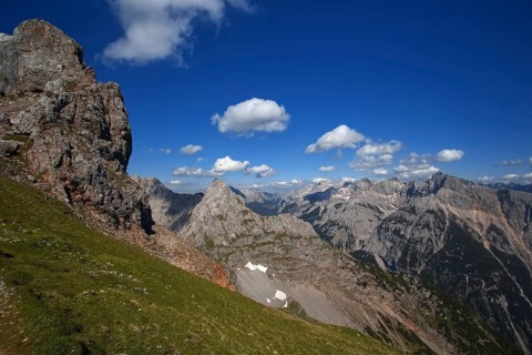 Fascinating view of high mountain peaks and clouds under a blue sky, Karwendel, Mittenwald,