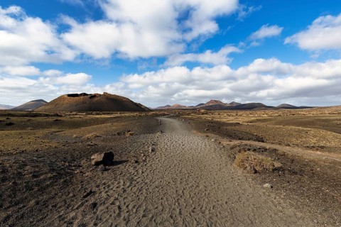 Hiking trail to the volcanic crater Caldera de Los Cuervos, lava fields, Los Volcanes nature park