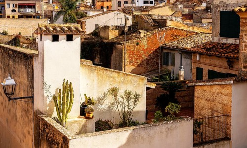 View of Mediterranean houses, roofs and courtyards from the town wall, Alcudia, Majorca, Spain,
