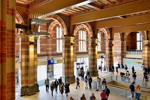 Interior view of Centraal Station, Central Station with flag, Amsterdam, Netherlands