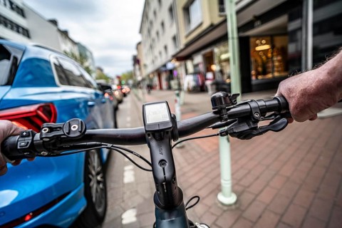 Cycling in the city, inner-city street, cycle lane, bicycles have priority, two-lane traffic with