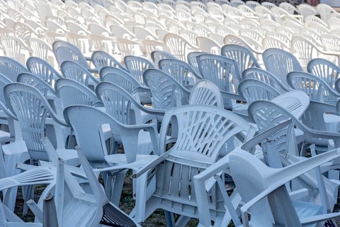 Seating for outdoor event, rows of chairs, overturned garden chairs made of plastic, plastic,
