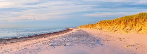 Sunny evening by the sea, unspoilt beach of the Baltic Sea with white sand at Darßer Ort in the