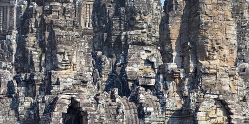 Panoramic image of giant stone-carved faces of the Bodhisattva Lokeshvara, also known as