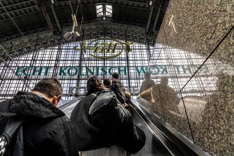 Cologne Central Station, escalators to and from the platform, passengers waiting for the train,