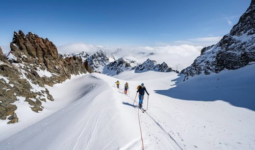 Ski tourer with rope, rope team on the Vadret da Porchabella glacier on the ascent to the summit of