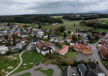 Drone shot, view of village with parish church, Rutzenmoos, Hausruckviertel, Upper Austria,