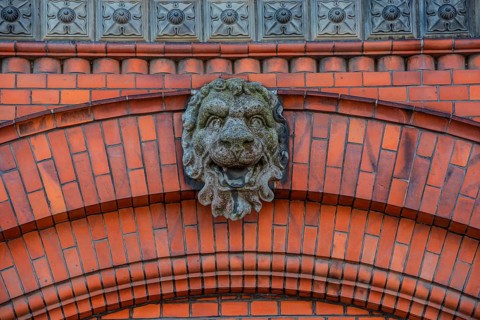 Lion head in concrete on decorative brick wall in Ystad, Skåne County, Sweden, Scandinavia, Europe