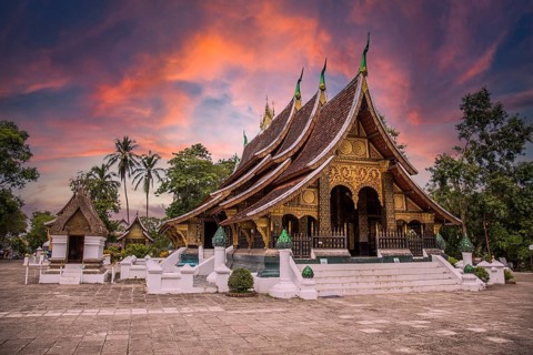Lovely sunset at a lovely temple in Luang Prabang in summer, Laos, Asia