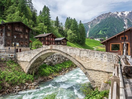 Village Binn, bridge over river Binna, traditional wooden houses, church, Valais, Switzerland,